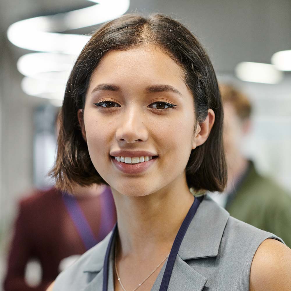portrait of joyful brunette businesswoman looking at camera in contemporary office